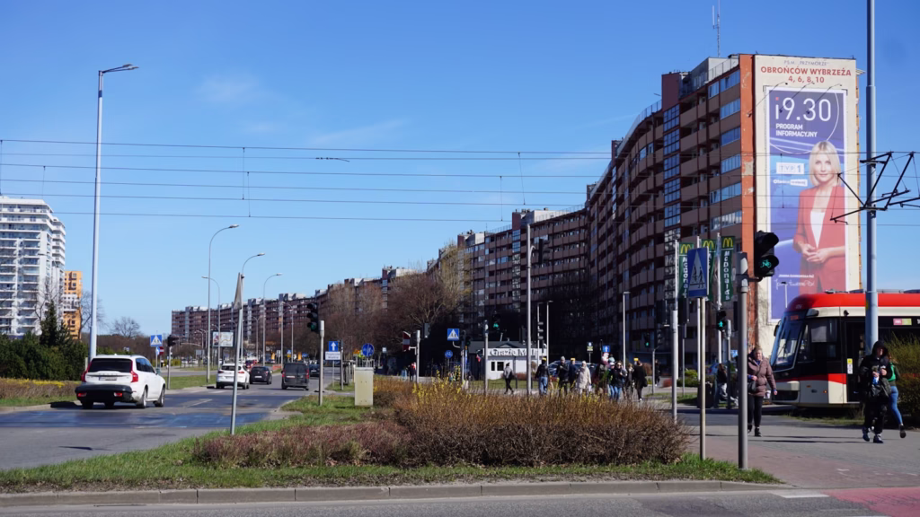 Urban street view with buildings and a bus.